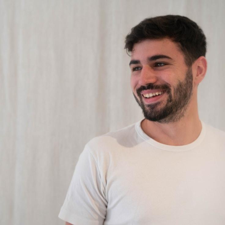 Jordan Lee, Lead Design Curator at Marble Route Summer, reviewing corporate floral arrangements